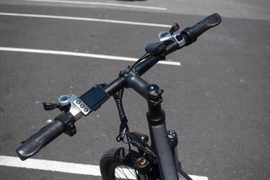 Electric bike handlebar setup with ergonomic grips and display controls

